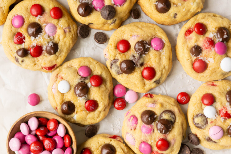valentines day cookies garnished with red, pink and white m&ms and dark chocolate chips.