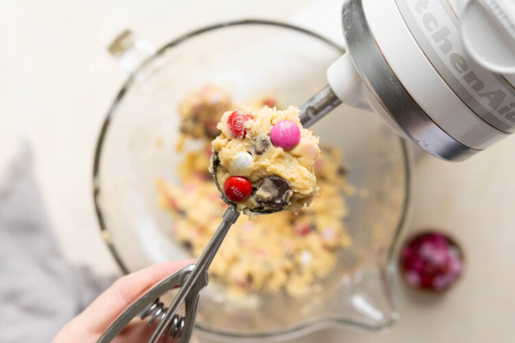 a cookie scoop with cookie dough in it.