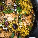 mediterranean chicken and yellow rice in a cast iron skillet