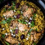 mediterranean chicken and yellow rice in a cast iron skillet