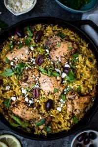 mediterranean chicken and yellow rice in a cast iron skillet