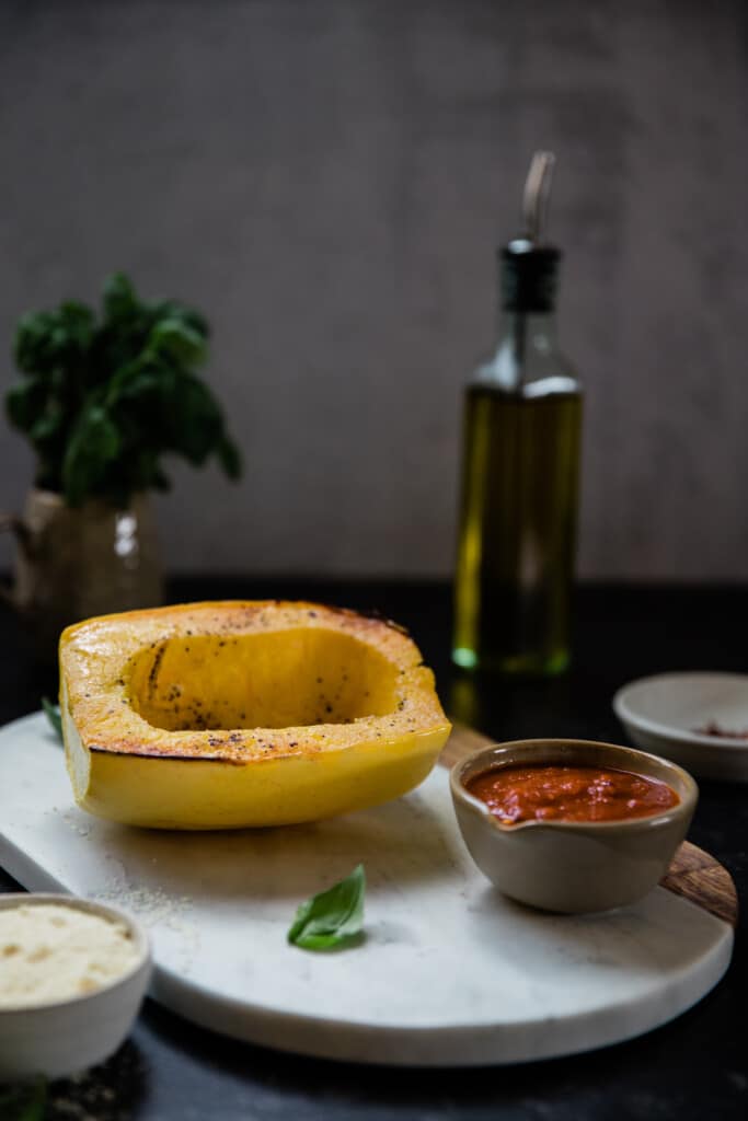 a cooked spaghetti squash on a marble board