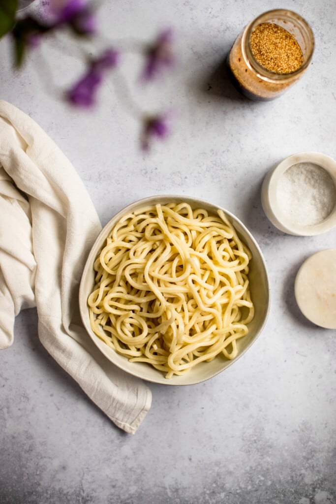 cooked udon noodles in a white bowl