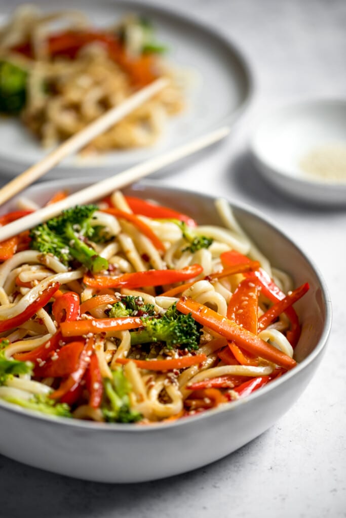 sesame udon noodles in a bowl with chopsticks