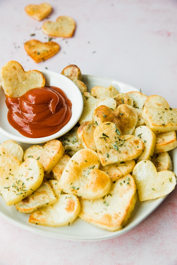 potatoes in the shape of hearts with ketchup