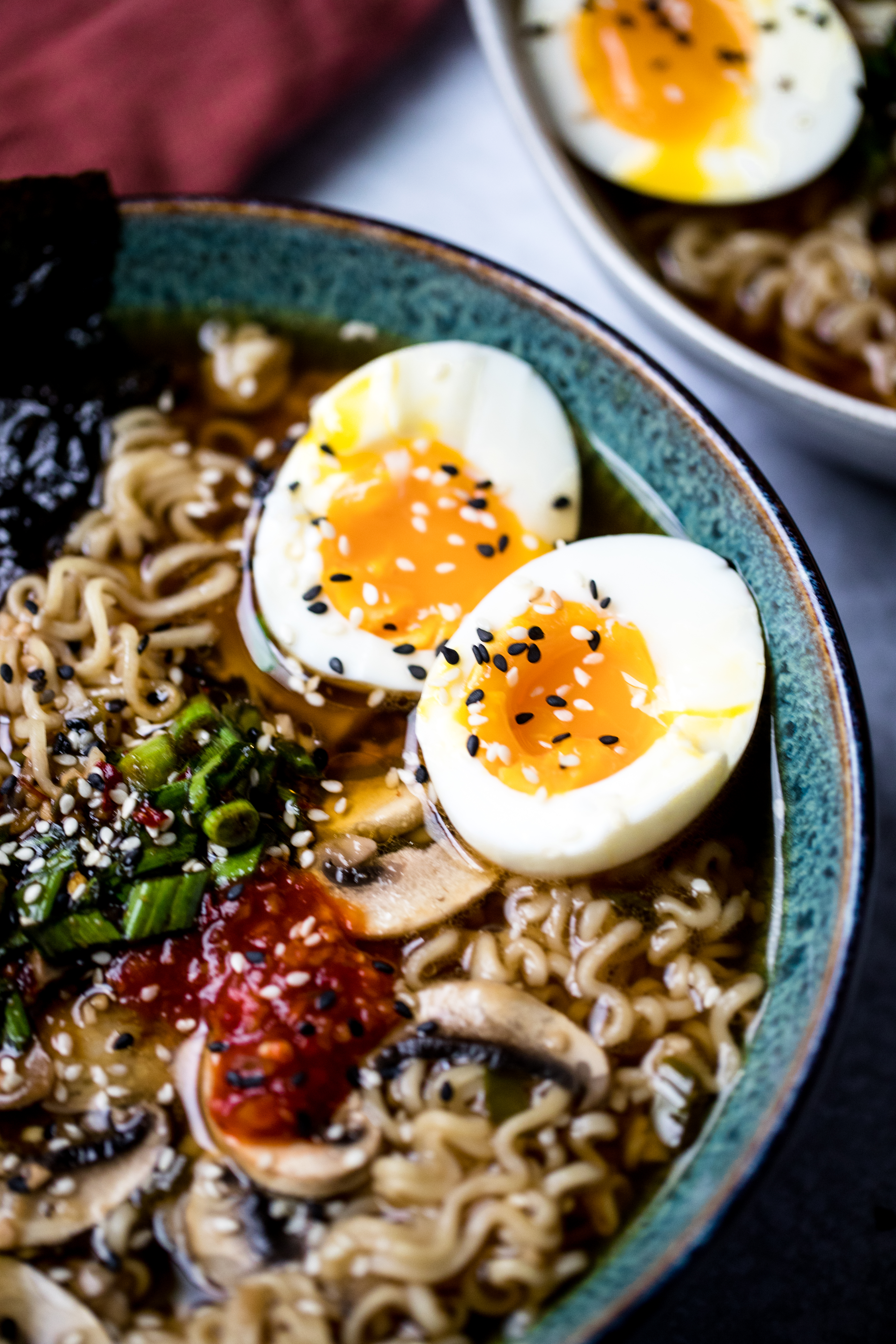 vegetarian ramen topped with soft boiled eggs, carrots, mushrooms, and broth