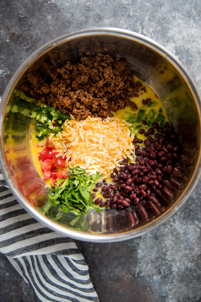 all of the fixing for taco egg muffins in a large bowl