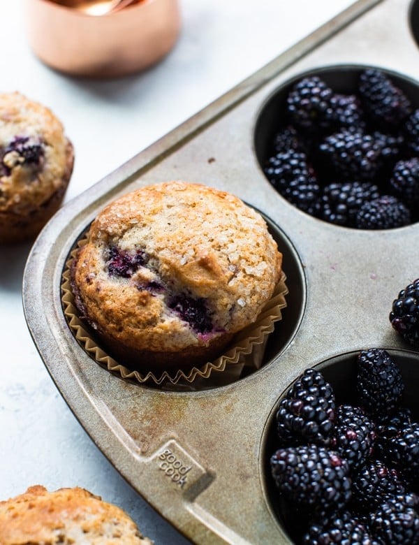 freshly baked blackberry muffins in a muffin tin