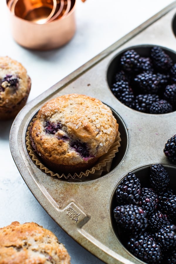 freshly baked blackberry muffins in a muffin tin