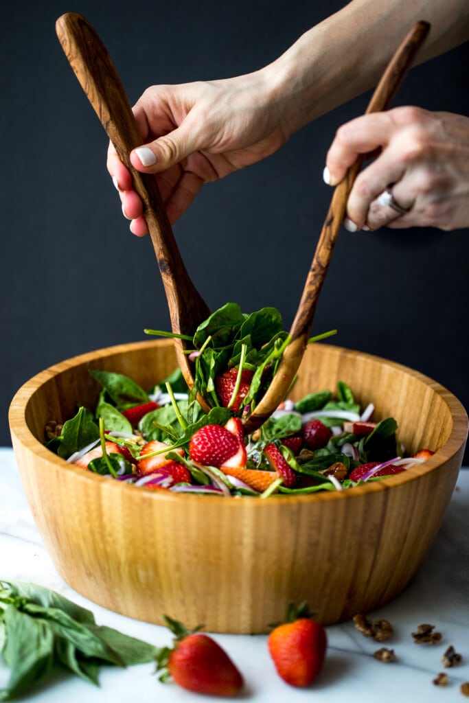 strawberry basil salad in a large wooden bowl