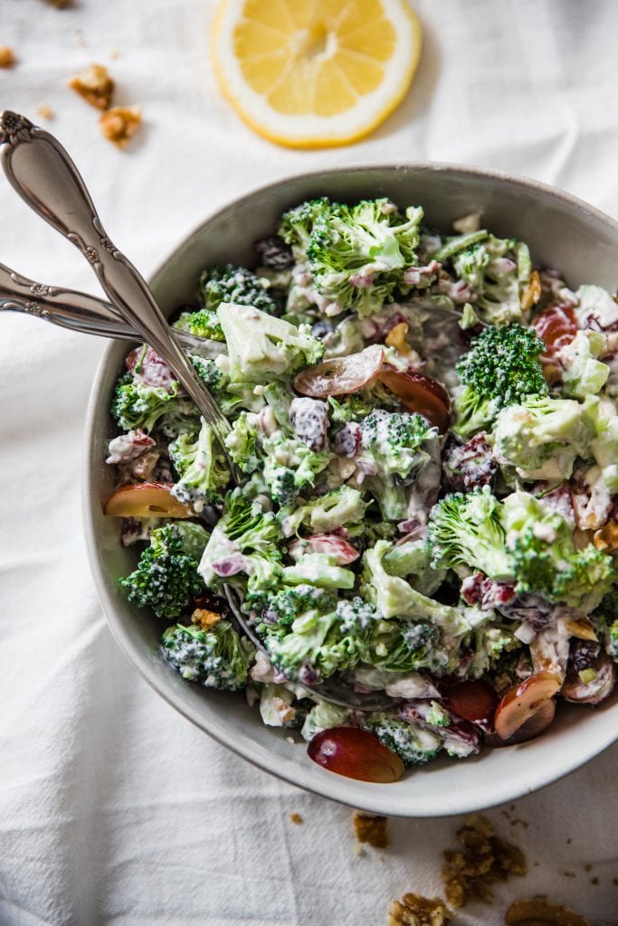 broccoli salad with grapes in a white bowl