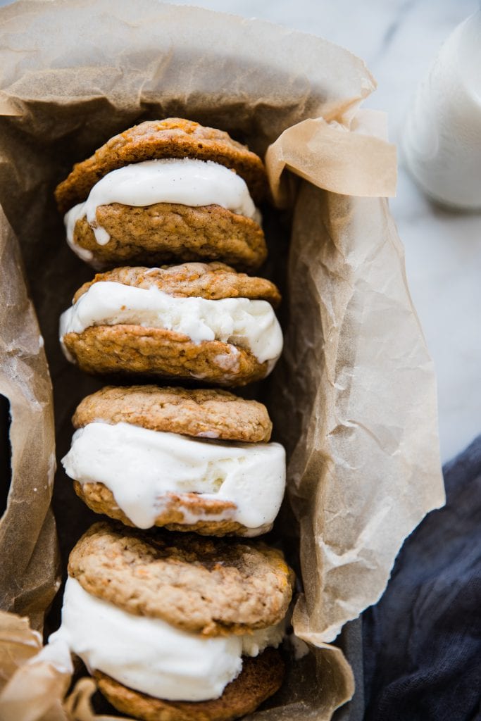 carrot cake ice cream sandwiches on parchment paper