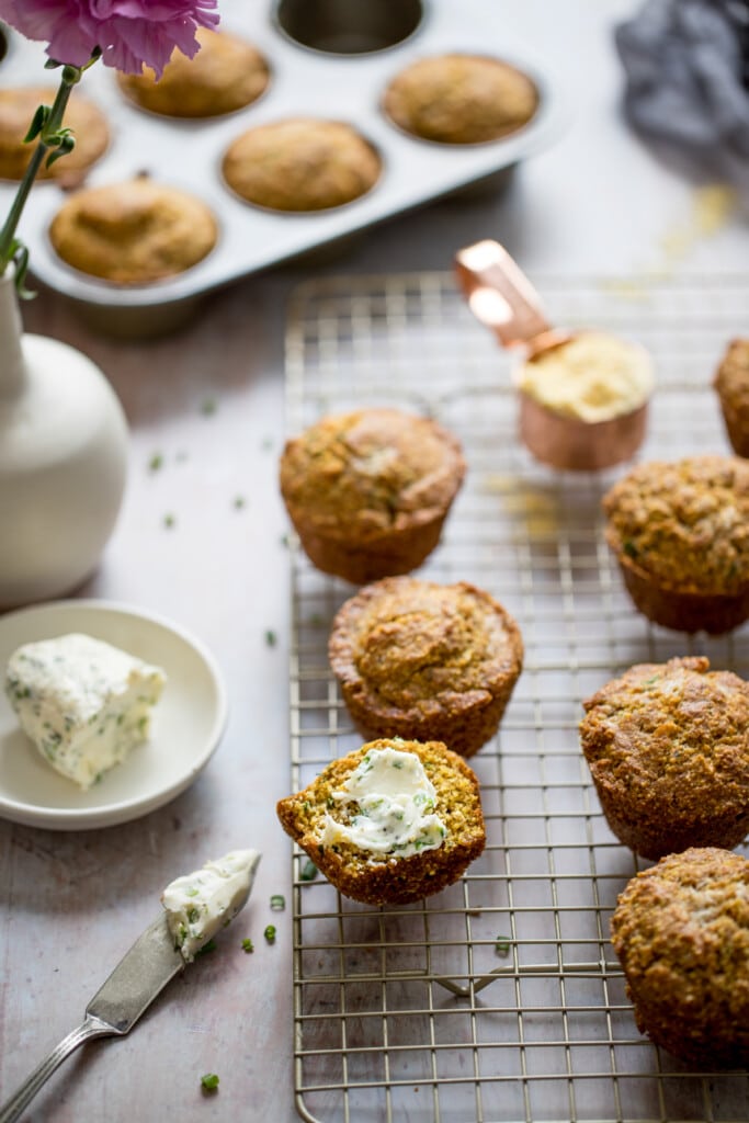 cornbread muffins with chive butter on a cooling rack