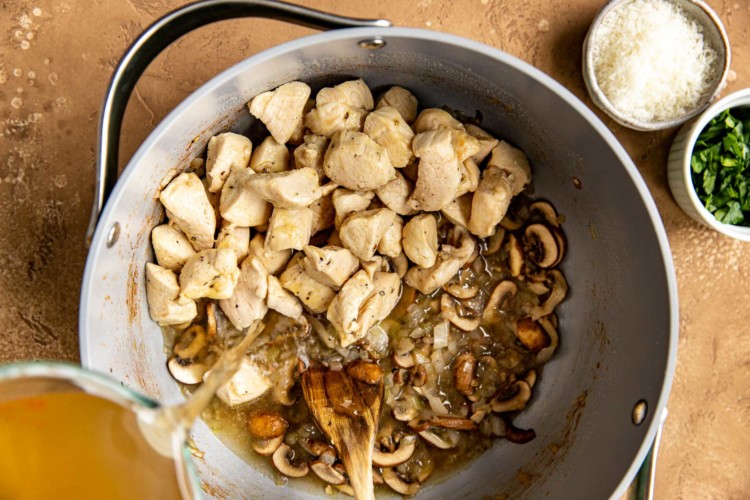 chicken, onions, mushrooms and chicken stock in dutch oven pan