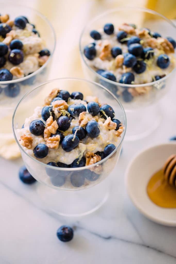 quinoa parfait in a glass parfait dish topped with blueberries