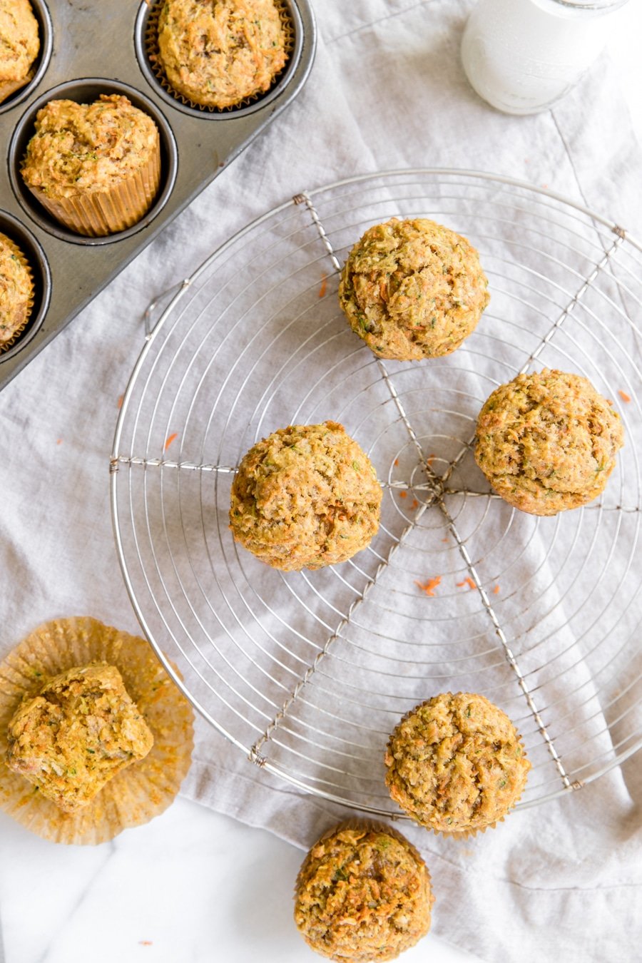 zucchini carrot muffins on a cooling rack