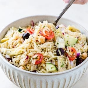 greek orzo pasta salad in a large white bowl