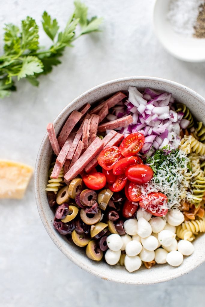 ingredients for Italian Pasta Salad in a large glass bowl