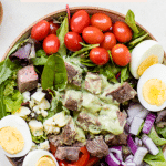 meal prep keto steak cobb salad with avocado dressing poured on top