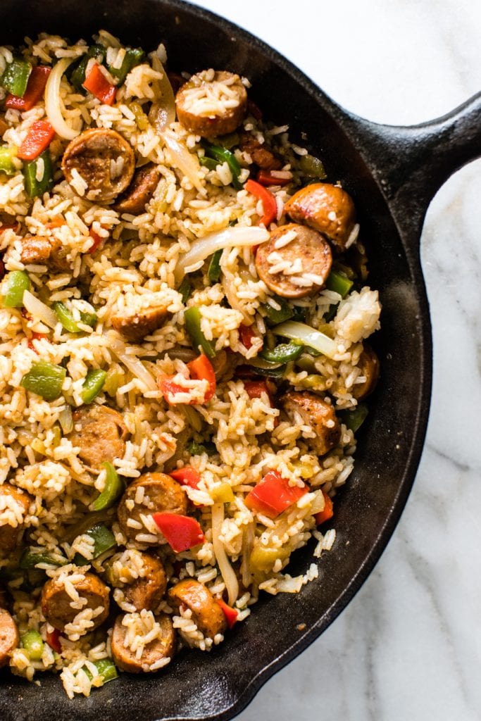 sausage, rice and bell peppers in a cast iron skillet
