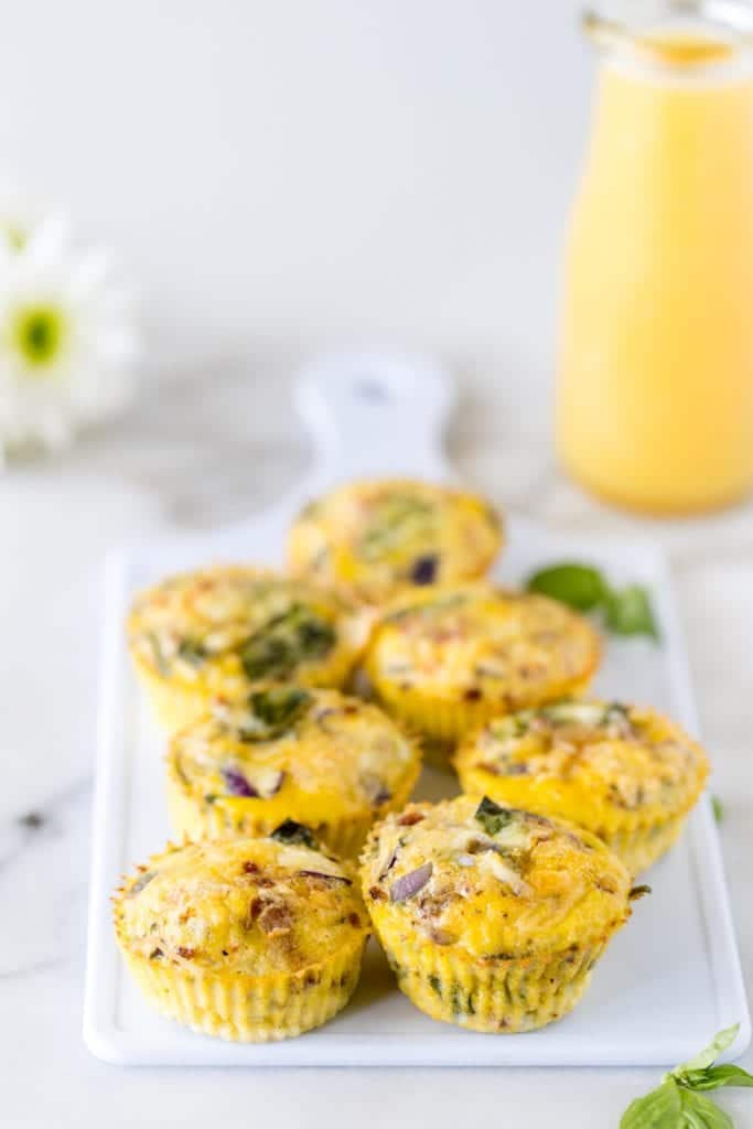 sun dried tomato egg muffins on a small white cutting board