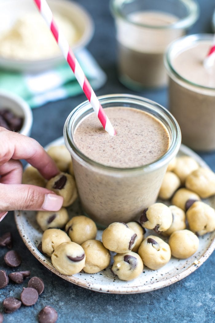a smoothie on a plate covered with balls of cookie dough