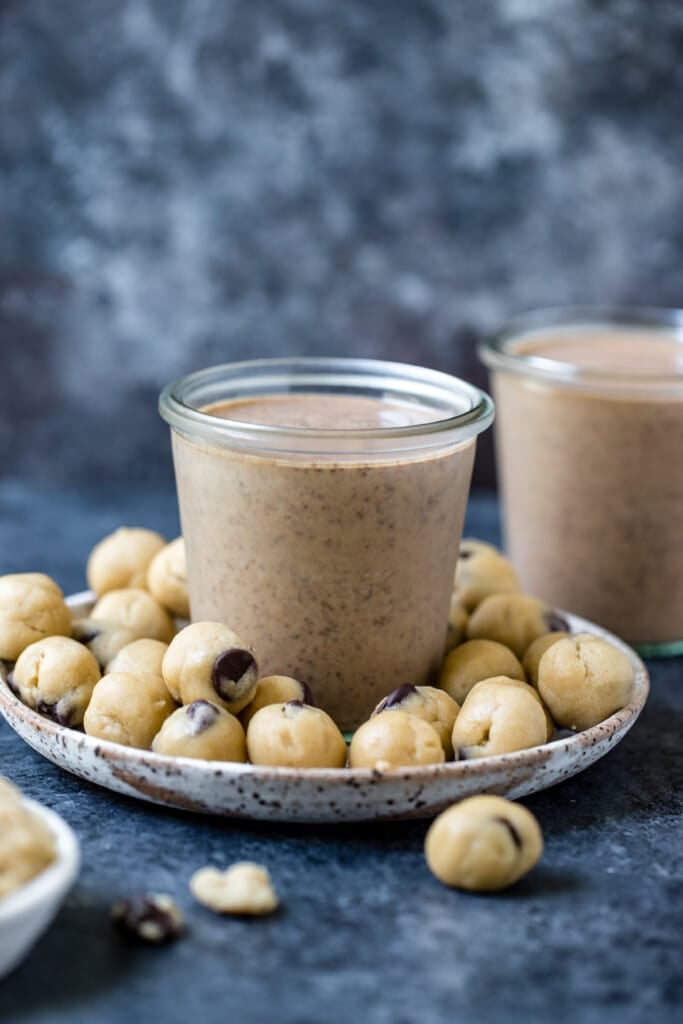 The BEST Cookie Dough Smoothie made with plant based ingredients such as vegan protein powder, almond milk, hemp seeds and creamy peanut butter. This delicious cookie dough smoothie is packed with antioxidants, plant protein and fiber for a healthy and satisfying snack! #smoothie #krollskorner #plantbased #healthy #easysmoothie