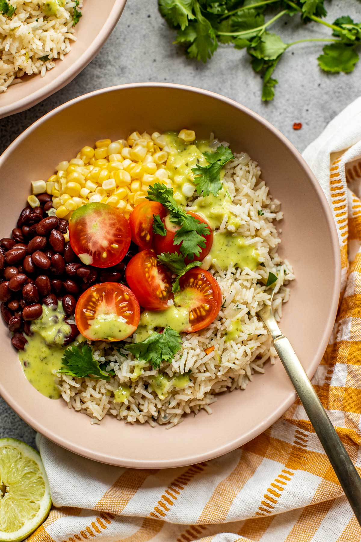 Cilantro lime rice in a bowl with black beans, corn, and tomatoes. 