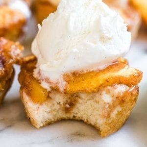 individual peach cobbler topped with vanilla ice cream