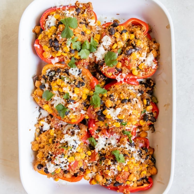 quinoa and veggies stuffed in a red bell pepper