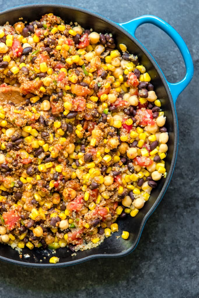 quinoa, corn and beans in a blue skillet