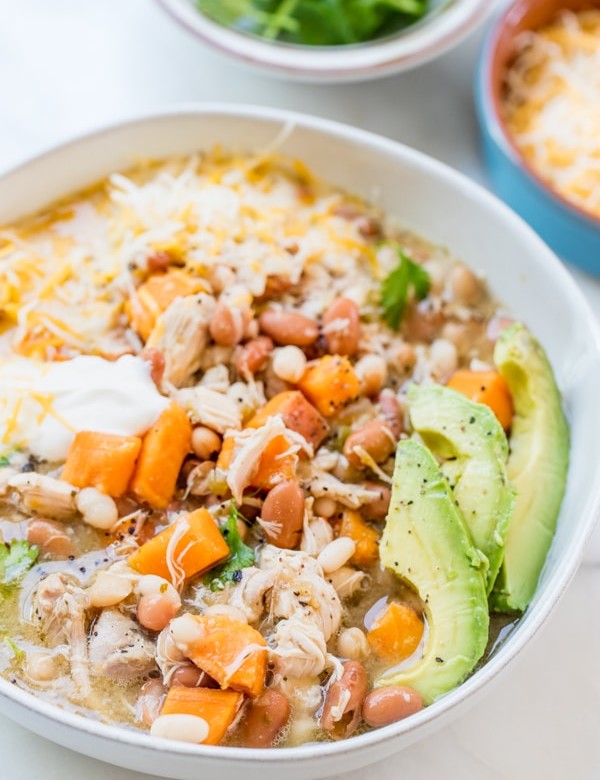 slow cooker green and white chicken chili in a white bowl