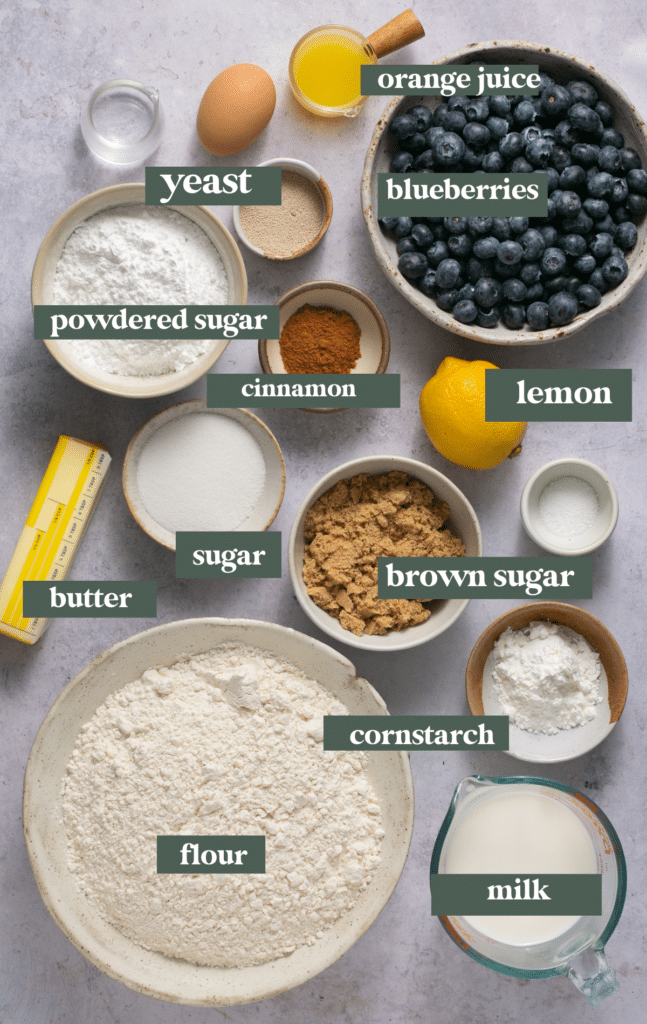 Ingredients needed to make blueberry cinnamon rolls in small glass dishes. 