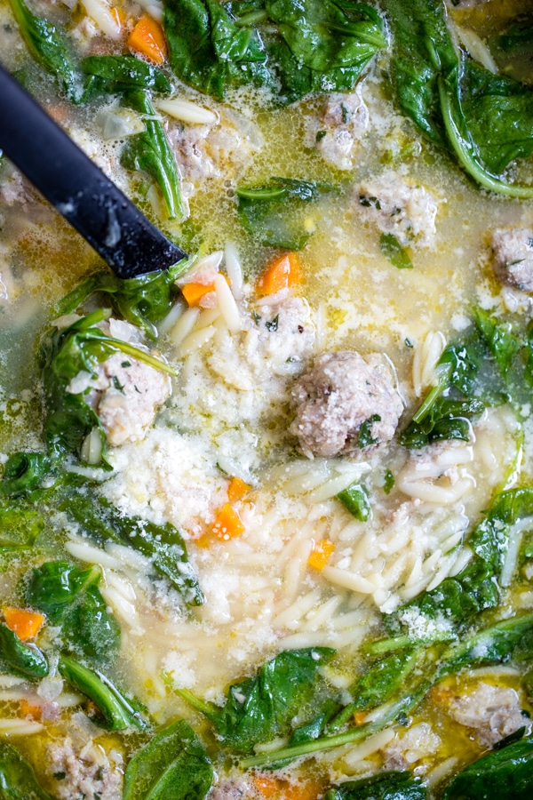 italian wedding soup recipe made with beef and pork meatballs in a large stock pot.