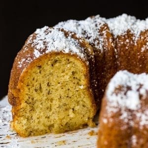 Bacardi rum cake on a cake stand with powdered sugar