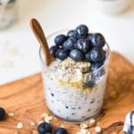 overnight oatmeal in a glass jar on a wooden cutting board