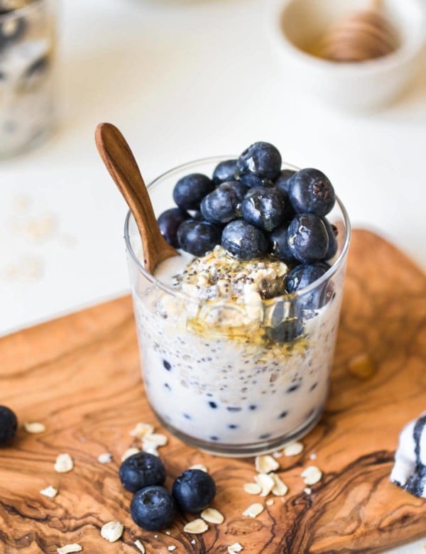 overnight oatmeal in a glass jar on a wooden cutting board
