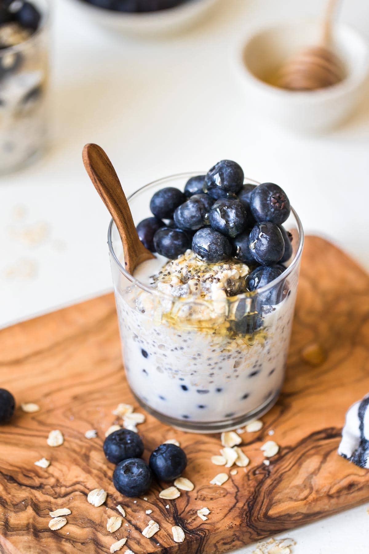 overnight oatmeal in a glass jar on a wooden cutting board