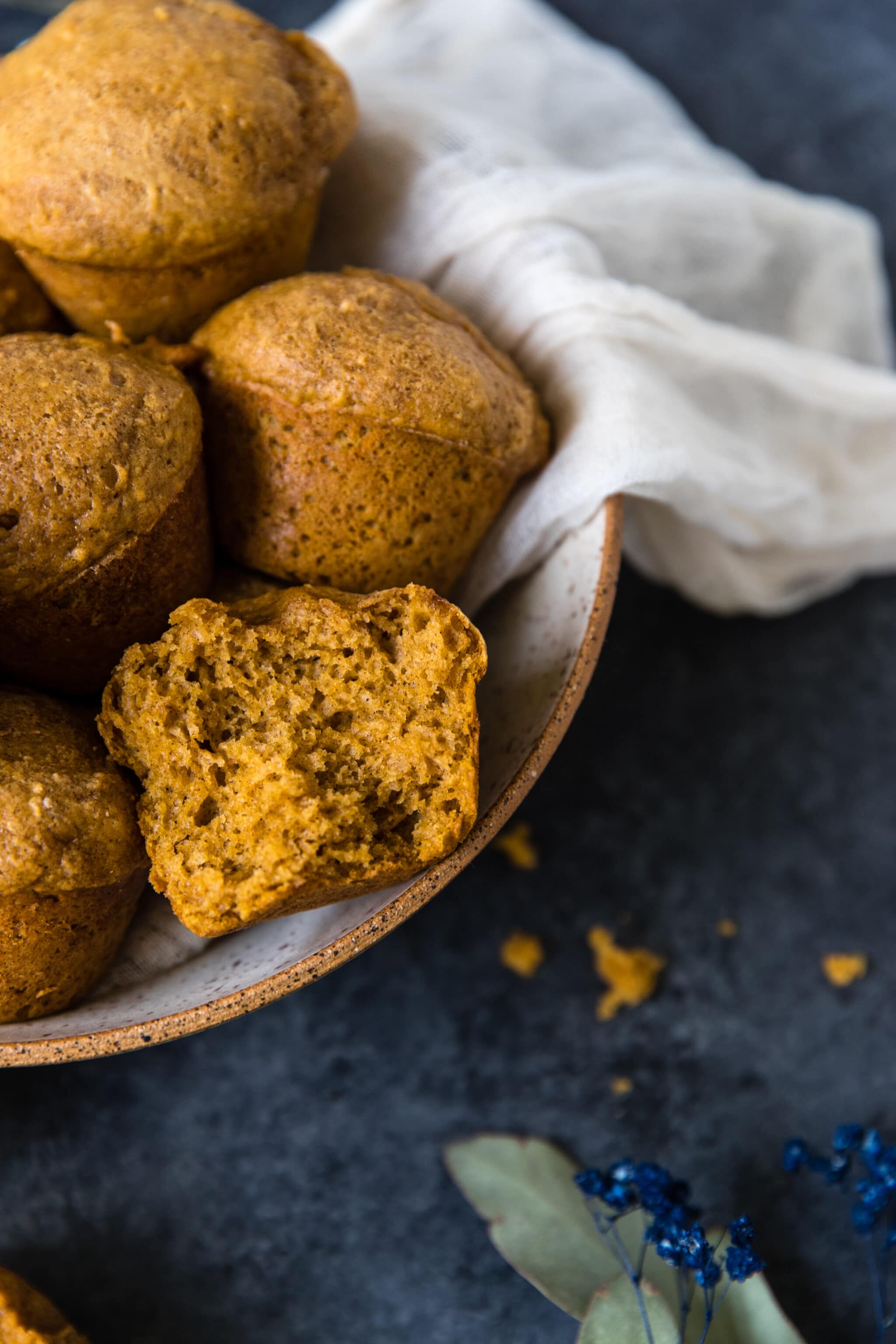 easy pumpkin muffin recipe in a large bowl with a white napkin