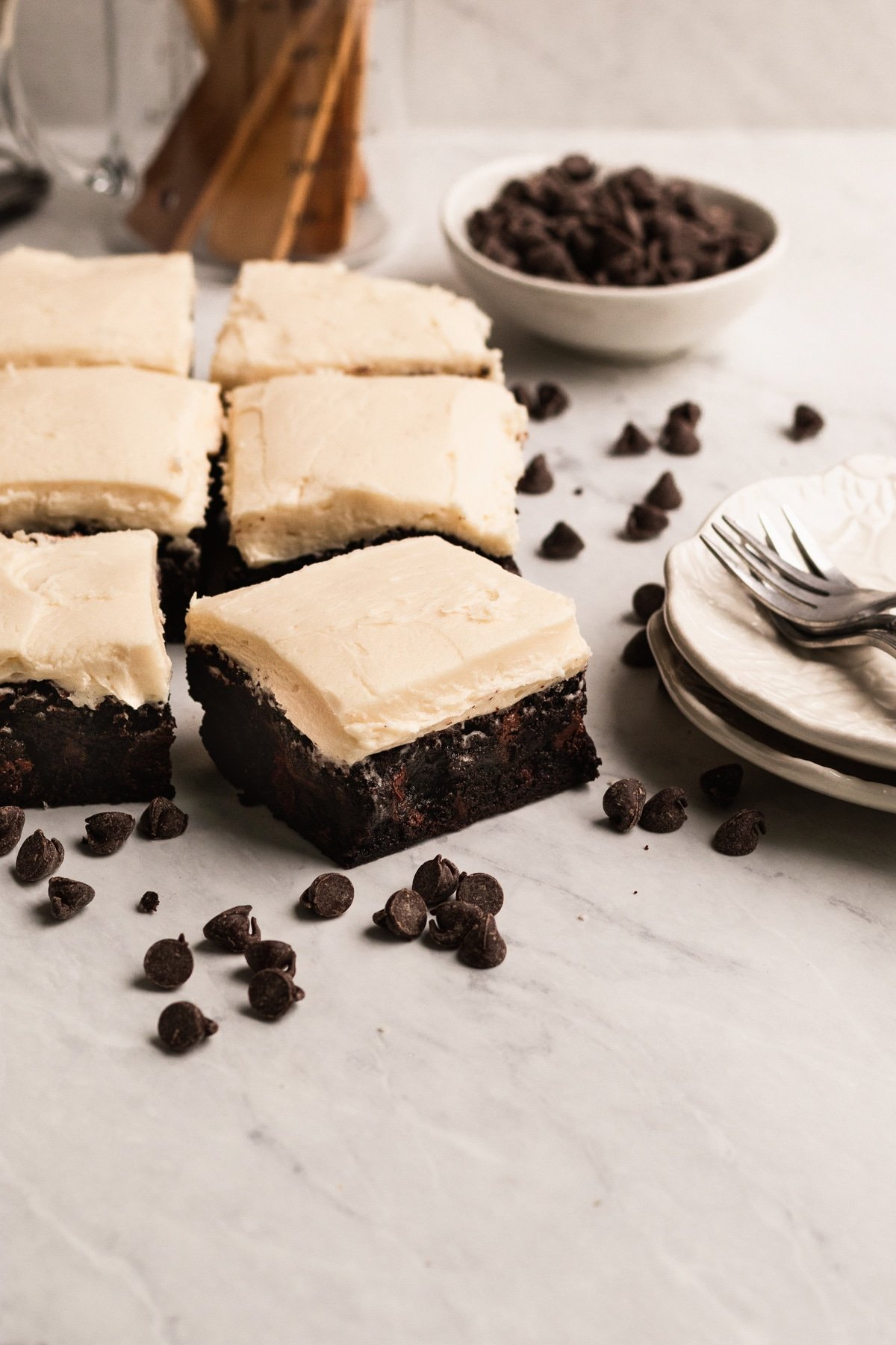 brownies on a marble board with frosting on top