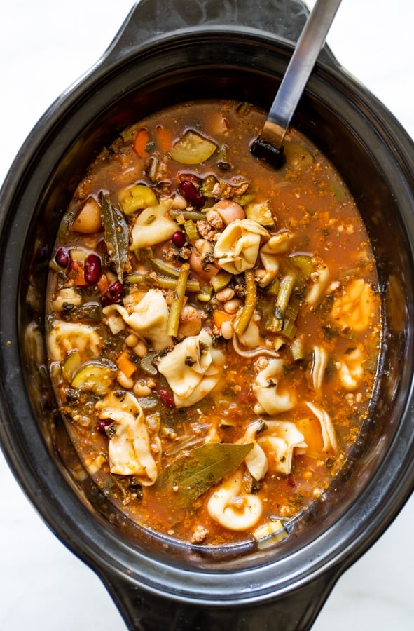 minestrone soup in a crockpot made with hearty vegetables and tortellini noodles