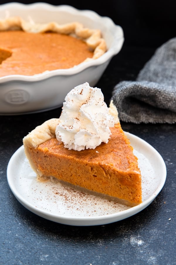 a slice of sweet potato pie on a white plate