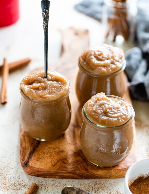 homemade applesauce in a glass jar with a spoon in it
