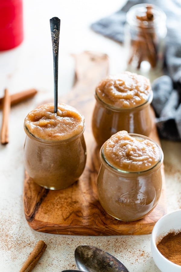 homemade applesauce in a glass jar with a spoon in it