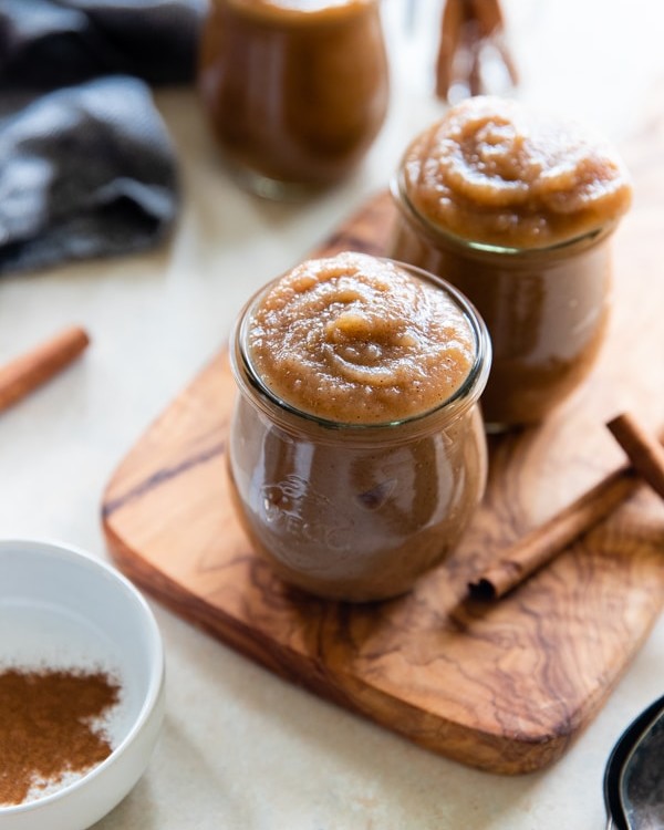 homemade applesauce in a glass jar with a spoon in it