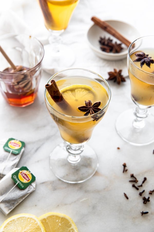 a lipton green tea hot toddy with whole star anise and a cinnamon stick and lemons