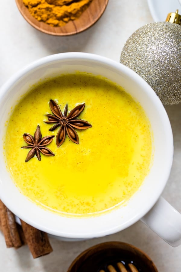 close up picture of a turmeric latte in white mugs