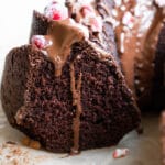 chocolate bundt cake with chocolate frosting and sugared cranberries