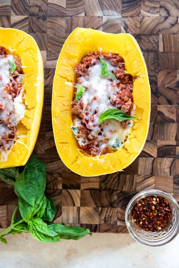 spaghetti squash with meat sauce on a wood cutting board