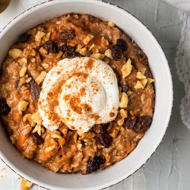 carrot cake oatmeal in a bowl topped with Greek yogurt and cinnamon